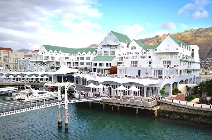 Med udsigt til både hav, både og bjergsilhuetter ligger Krystal Beach Hotel smukt på Harbour Island i Gordon’s Bay. 